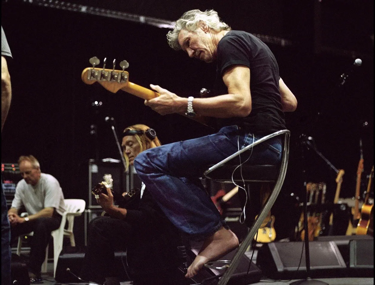 Roger Waters on stage, with his bare feet