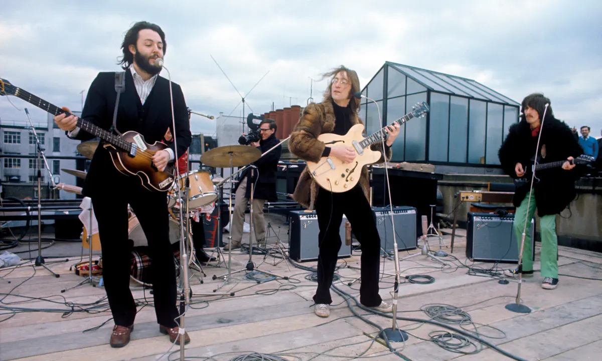 The Beatles performing on a rooftop
