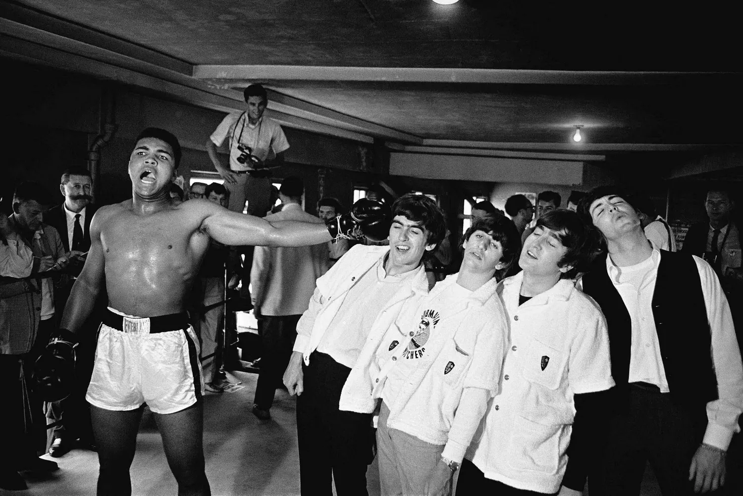 The Beatles posing with Muhammad Ali