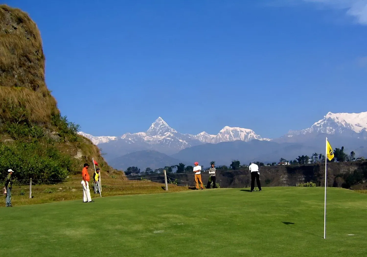 Golf course with the snow-capped Himalayas