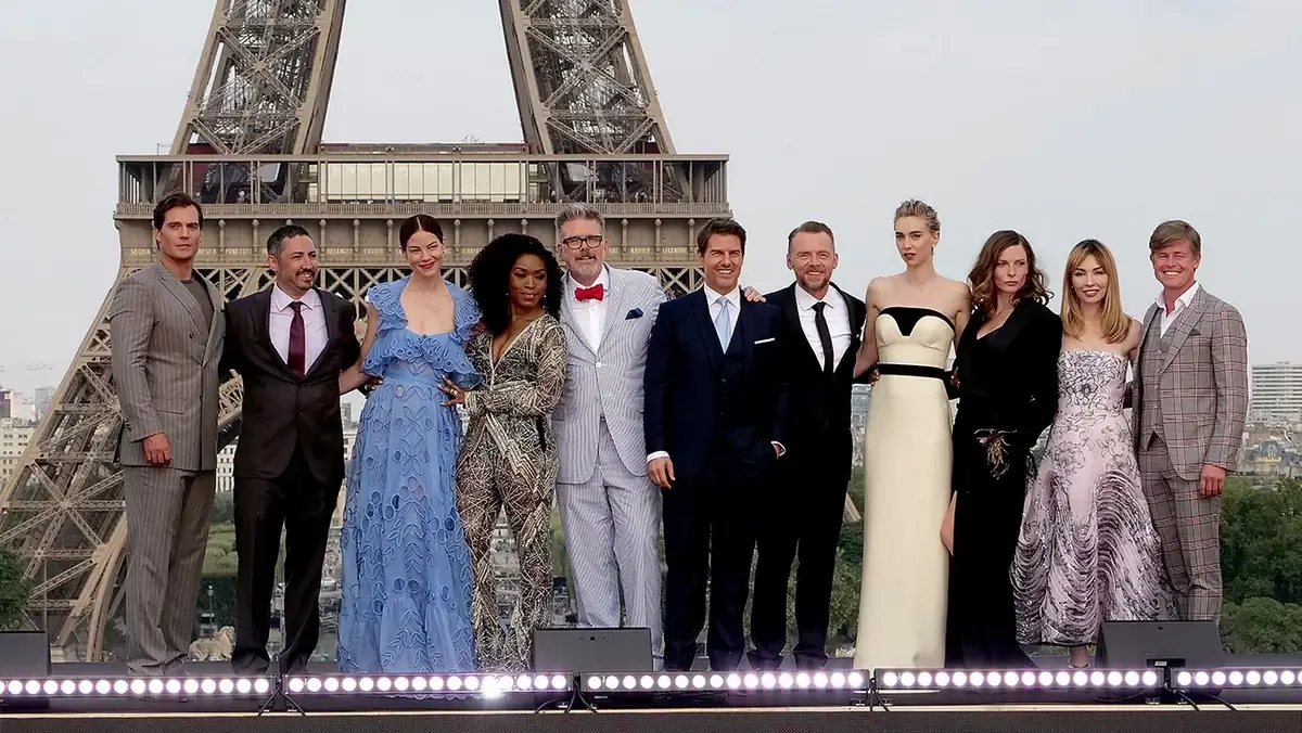 Celebrities posing with the Eiffel Tower in the background