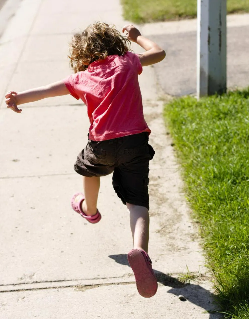 Kid hopping over cracks on the sidewalk