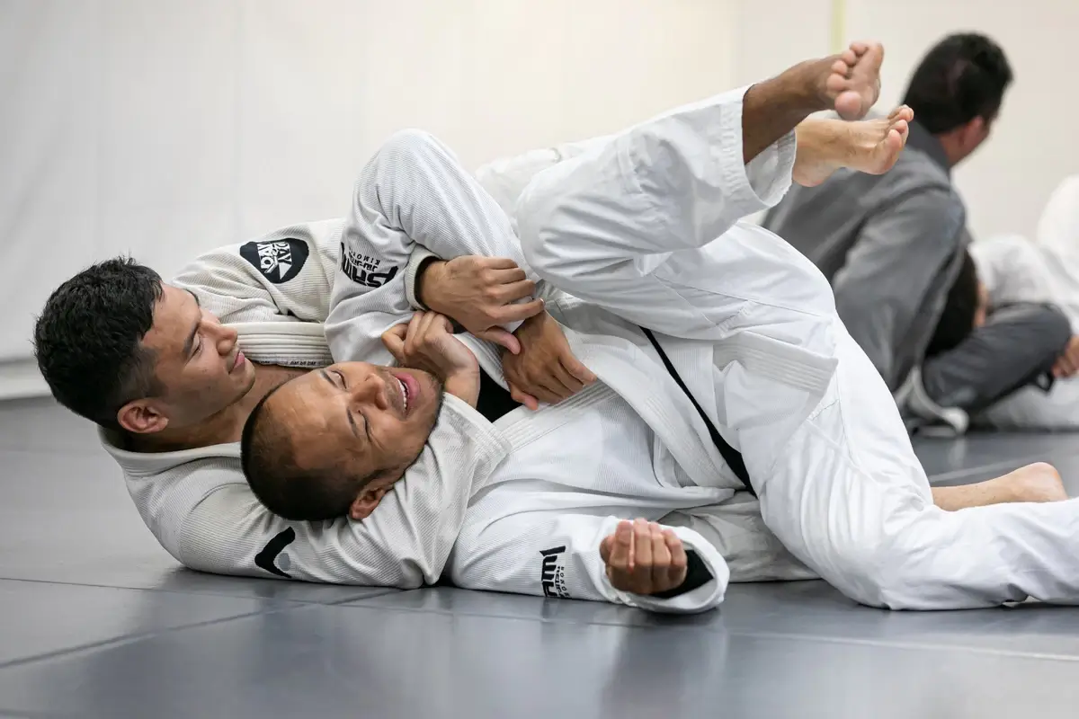 Two Jiu-Jitsu practitioners demonstrating a classic ground technique