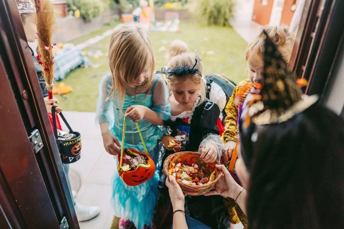 Kids trick-or-treating with candies