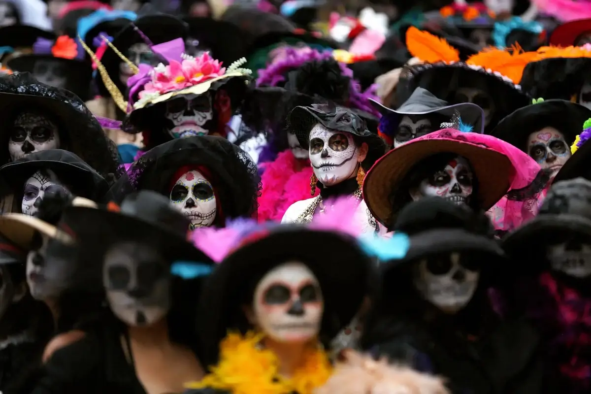 People dressed in traditional costumes with calavera face paint
