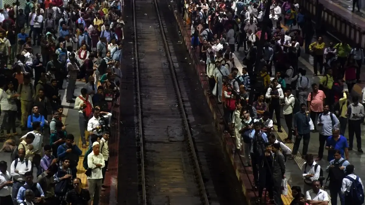 A bustling Mumbai local train station during peak hours