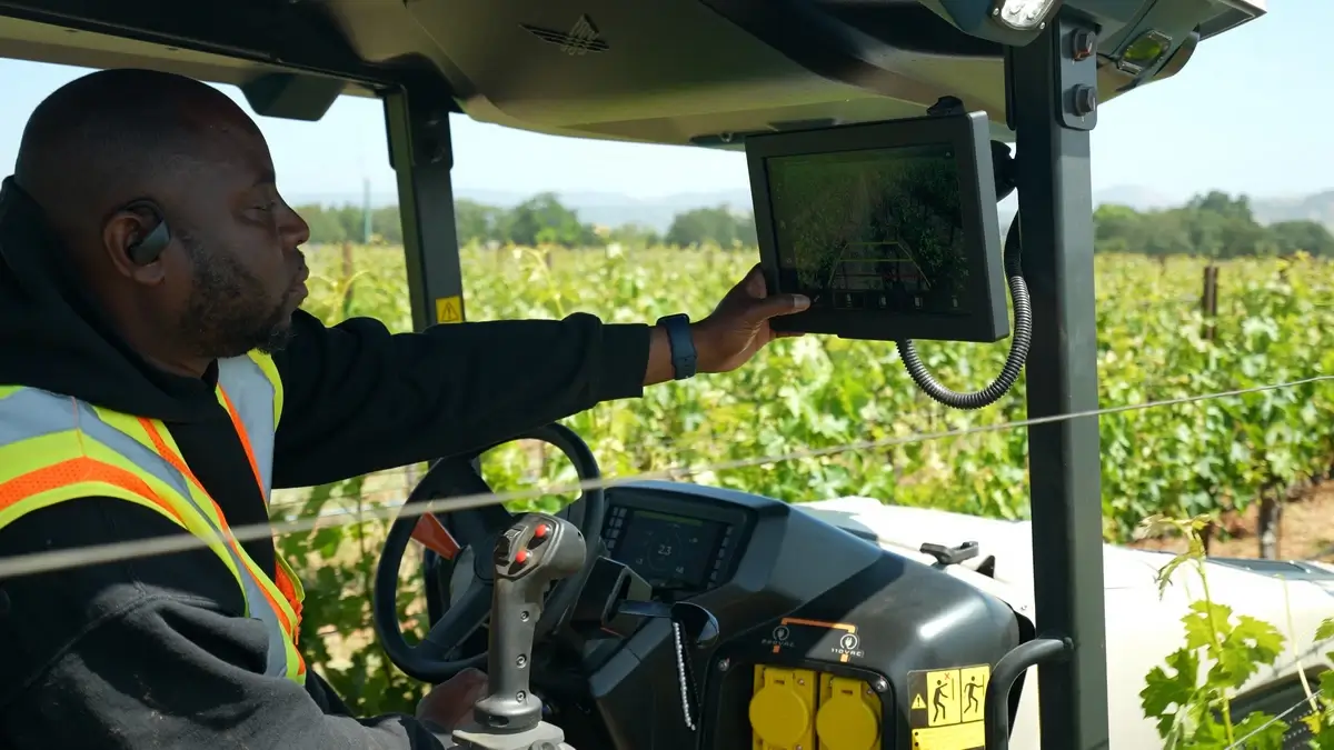 Farmers using advanced GPS equipment in their tractors
