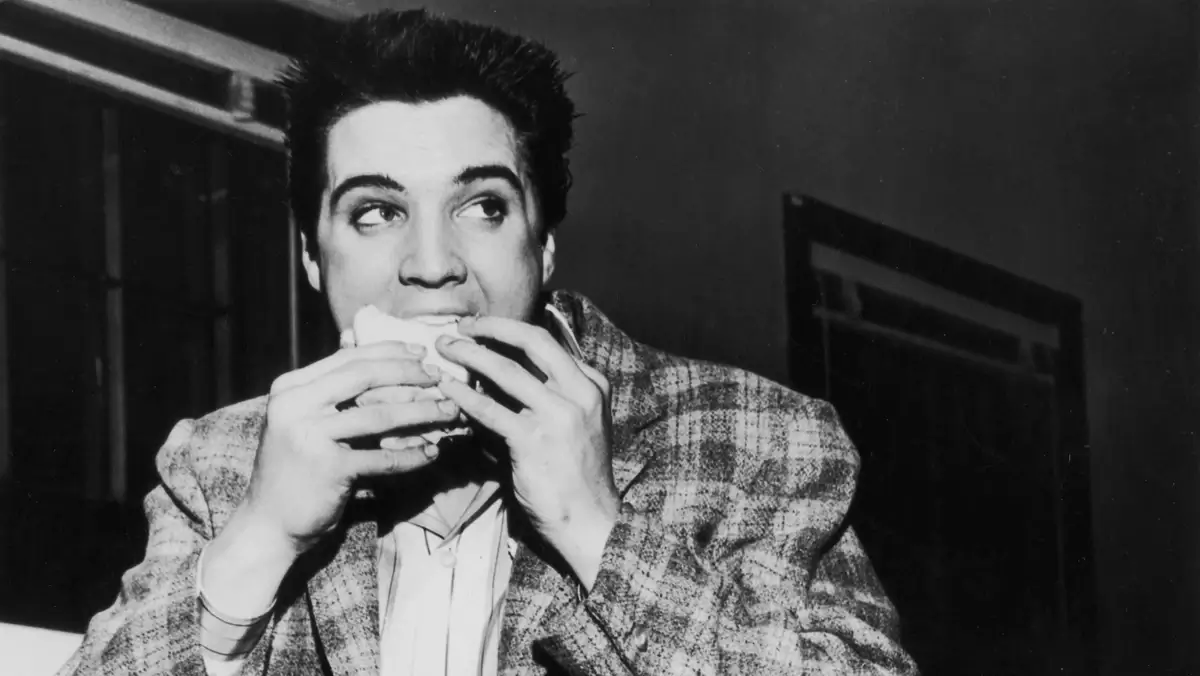 Elvis Presley eats a peanut butter sandwich