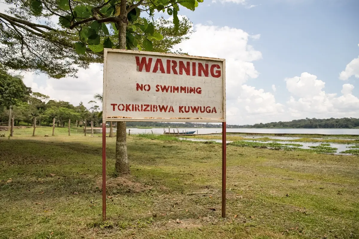 A sign warning about Bilharzia near a Ugandan lake