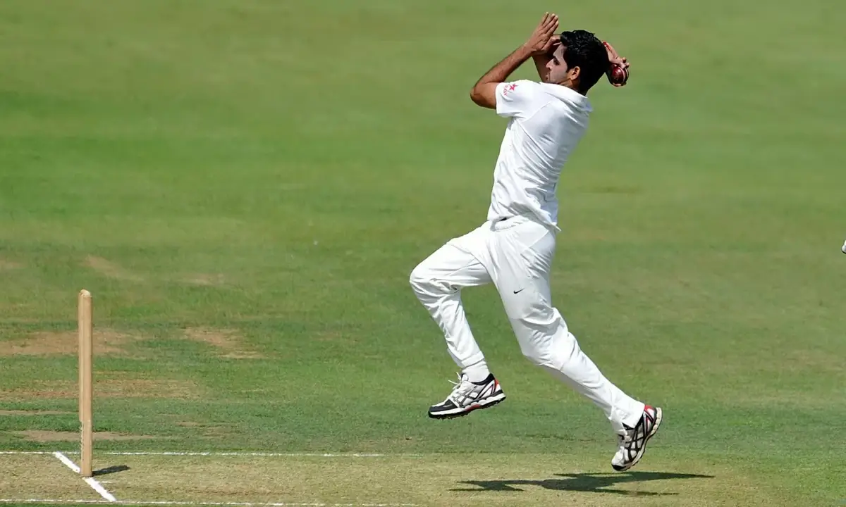 A spin bowler in action during a cricket match