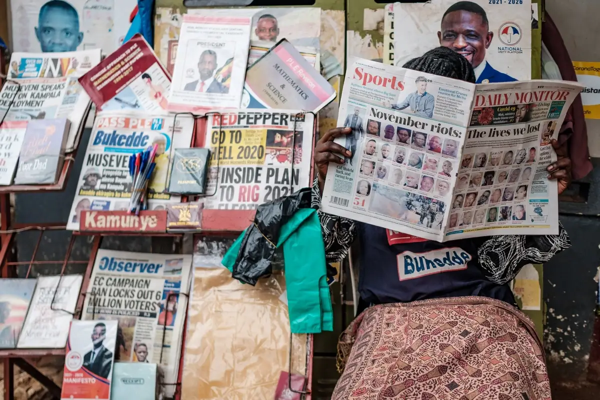 A woman in Uganda reads a newspaper