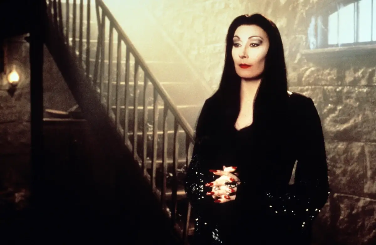 Anjelica Huston in full Morticia Addams makeup and costume
