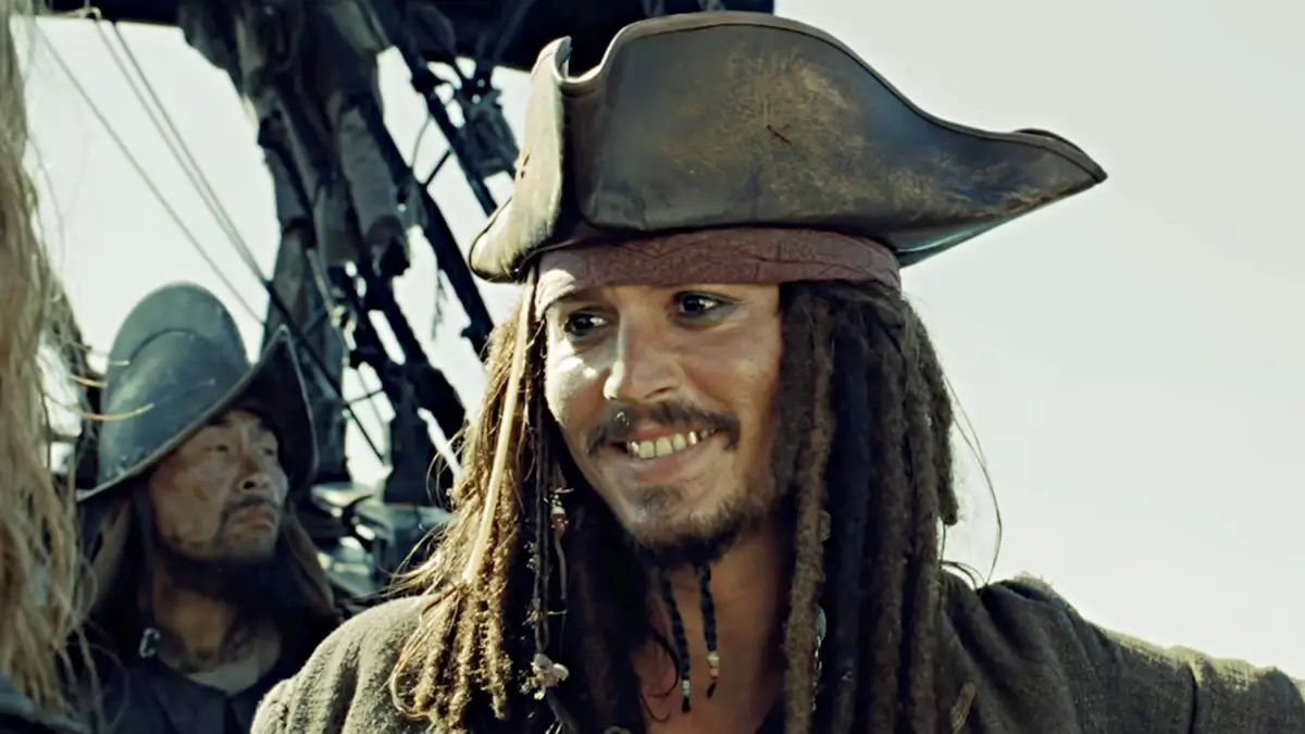 Captain Jack Sparrow smiles showing his gold teeth