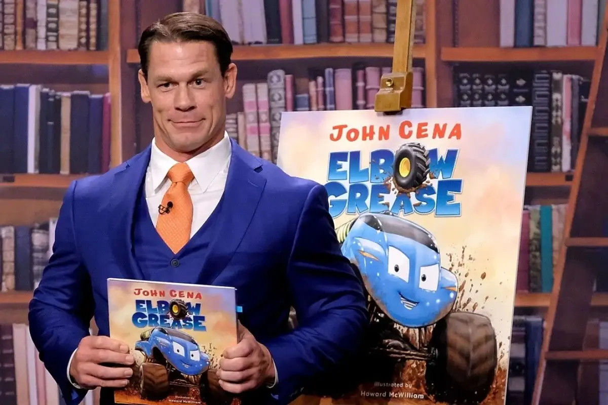John Cena holding his book "Elbow Grease"