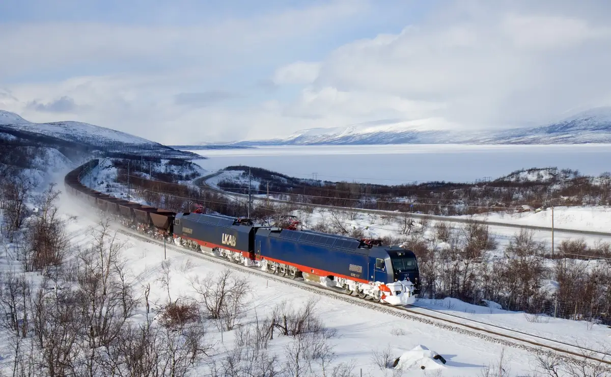 An ore train winding through the snowy landscapes of Northern Sweden
